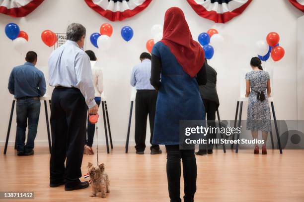 voters waiting to vote in polling place - hijab woman from behind stock pictures, royalty-free photos & images