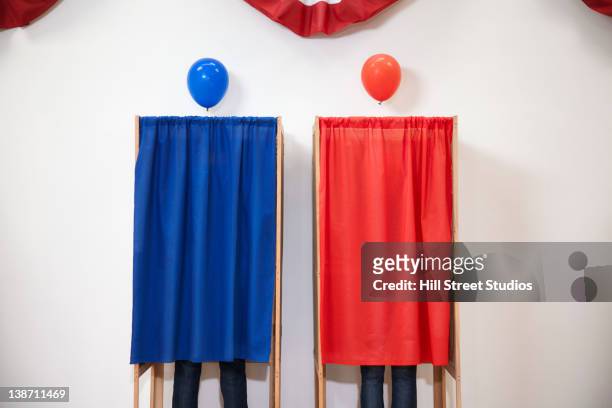 voters voting in polling place - politische partei stock-fotos und bilder