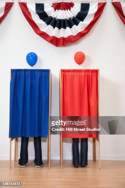 voters voting in polling place - voting booth stock pictures, royalty-free photos & images