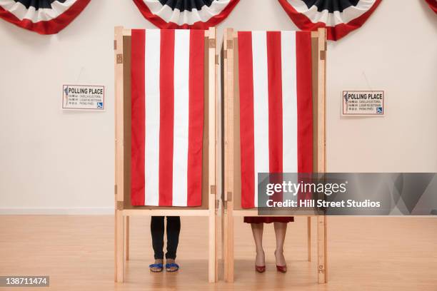 voters voting in polling place - voting booth stock pictures, royalty-free photos & images