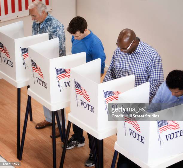 voters voting in polling place - polling place fotografías e imágenes de stock