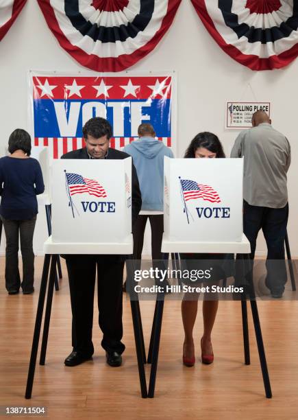 voters voting in polling place - wahlkabine stock-fotos und bilder
