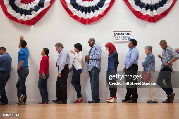 voters waiting to vote in polling place - democracy stock pictures, royalty-free photos & images