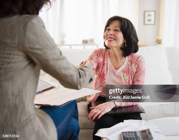 woman shaking hands with financial advisor - customer appreciation stock pictures, royalty-free photos & images