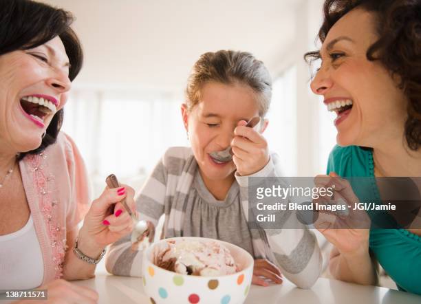family eating ice cream together - mulher colher sorvete imagens e fotografias de stock