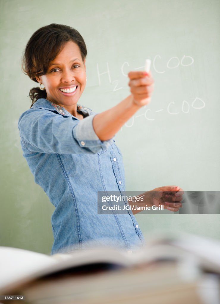 Black woman teaching in classroom