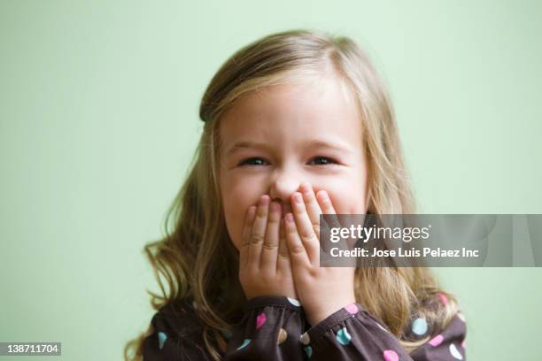 caucasian girl covering her mouth - kid laughing stock-fotos und bilder