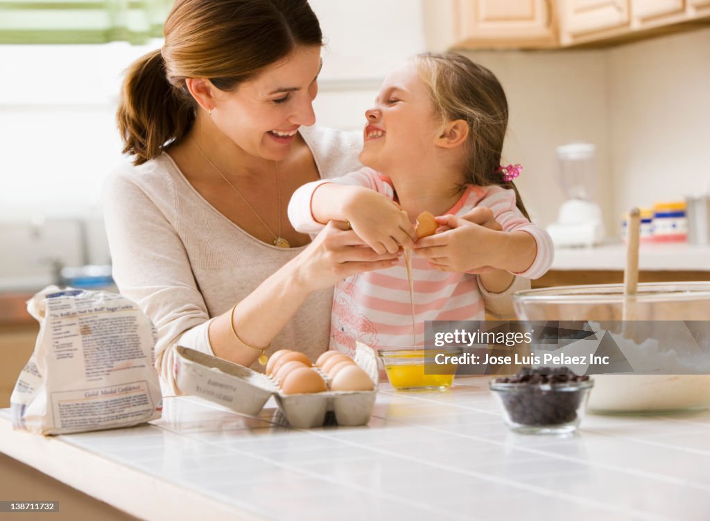 Caucasian mother and daughter baking together