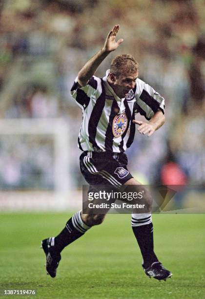 Newcastle United striker Alan Shearer celebrates after scoring the second Newcastle goal and his first for the club with his trademark one armed...