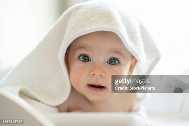 baby wearing towel after bath - wrapped in a towel stock pictures, royalty-free photos & images