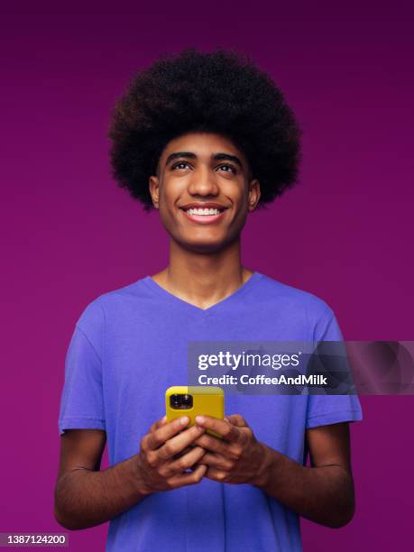 portrait of funny afro guy using phone - funny black people faces stock pictures, royalty-free photos & images