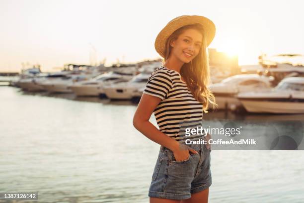 portrait of a woman walking near marina - marina stock pictures, royalty-free photos & images