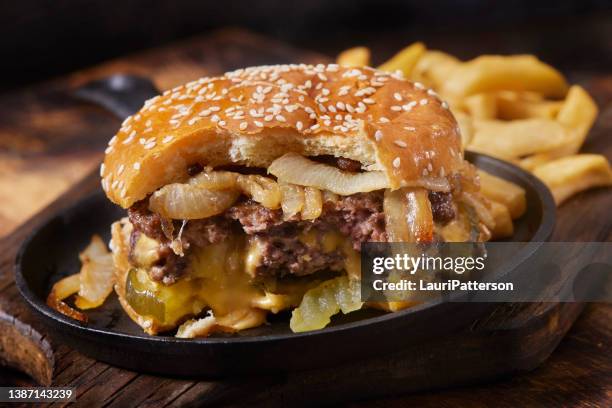 the juicy lucy stuffed cheeseburger with fried onions - juicy lucy stock pictures, royalty-free photos & images