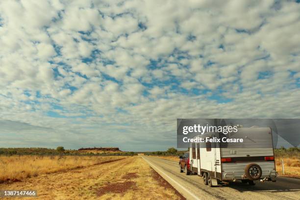 cruising around the country by a caravan. - camping australia stock-fotos und bilder