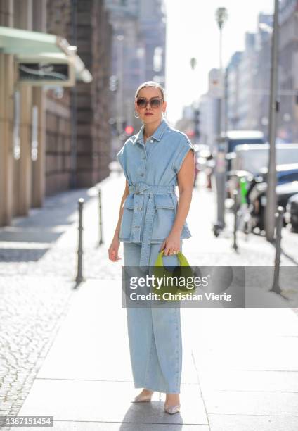 Tina Haase is seen wearing Selected Femme Denim vest & wide leg jeans, Mango crystal clear perspex heels, Loewe sunglasses, &other stories lemon...