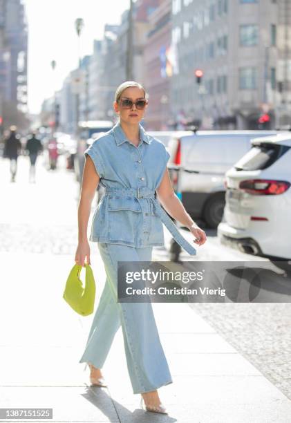 Tina Haase is seen wearing Selected Femme Denim vest & wide leg jeans, Mango crystal clear perspex heels, Loewe sunglasses, &other stories lemon...