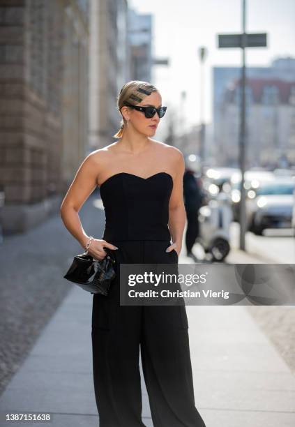 Tina Haase is seen with hair clips wearing black Gestuz Corsage top & Baggy cargo pants, Chanel sunglasses , Decadent Copenhagen black croco bag,...