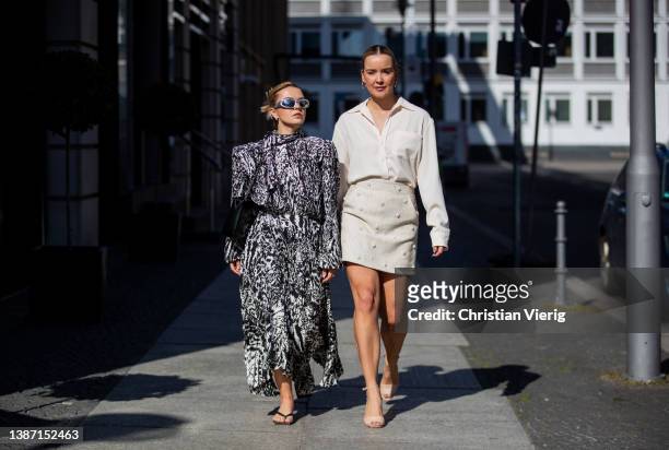 Amelie Stanescu is seen wearing black white Balenciaga dress, silver Balenciaga sunglasses, black weat bag, arket sandals shoes &Tina Haase is seen...