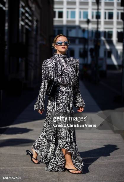 Amelie Stanescu is seen wearing black white Balenciaga dress, silver Balenciaga sunglasses, black weat bag, arket sandals shoes during Berlin Fashion...