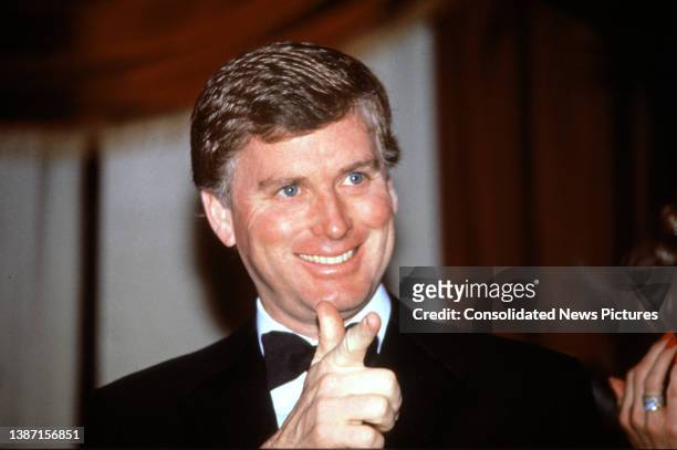Vice President-elect Dan Quayle smiles and points as he attends at a dinner at the Pension Building, Washington DC, January 18, 1989.