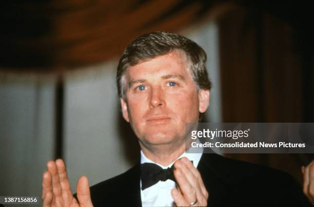 Vice President-elect Dan Quayle applauds as he attends at a dinner at the Pension Building, Washington DC, January 18, 1989.