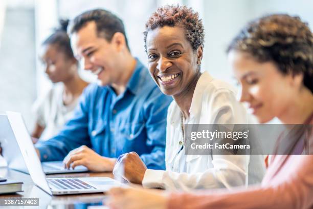 mature students working together - adult learning stock pictures, royalty-free photos & images