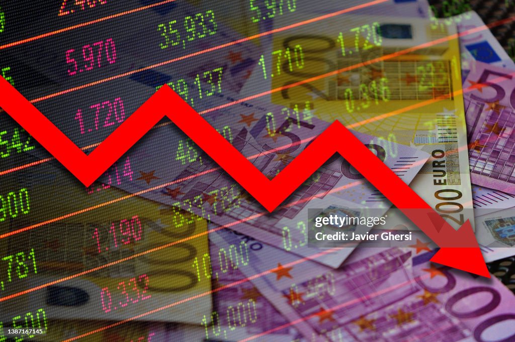 Economy graph: red down arrow, cash euro banknotes and stock exchange board