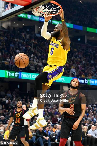 LeBron James of the Los Angeles Lakers dunks during the first quarter against the Cleveland Cavaliers at Rocket Mortgage Fieldhouse on March 21, 2022...