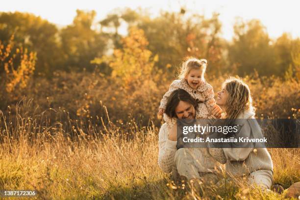 heterosexual family with a small child in nature. - baby lachen natur stock-fotos und bilder
