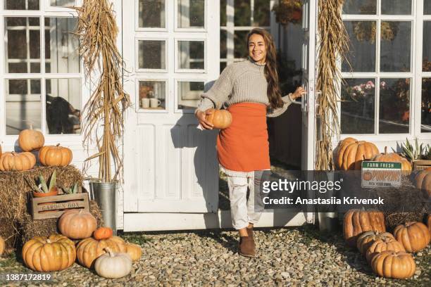 woman on a harvest festival at pumpkin farm. - erntefest stock-fotos und bilder