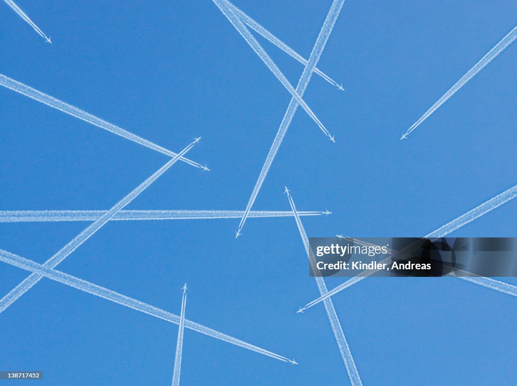 Airplanes against blue sky, directly below