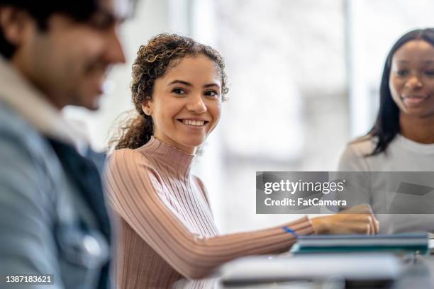 female university student studying with peers - financial education stock pictures, royalty-free photos & images