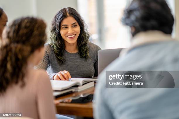 female university student studying with peers - indian college stockfoto's en -beelden
