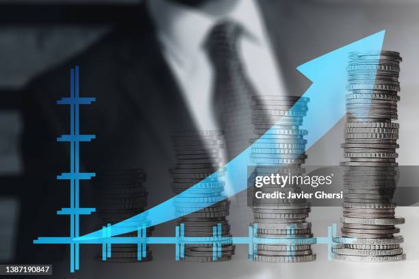 economy graph: stacked coins and rising arrow - billets euros stock pictures, royalty-free photos & images