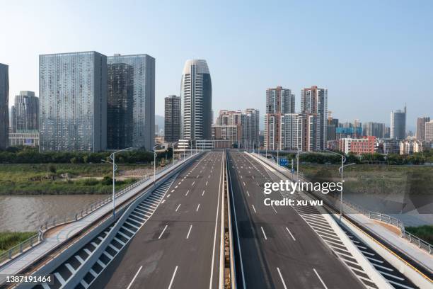 road in front of city buildings - empty road above stock pictures, royalty-free photos & images