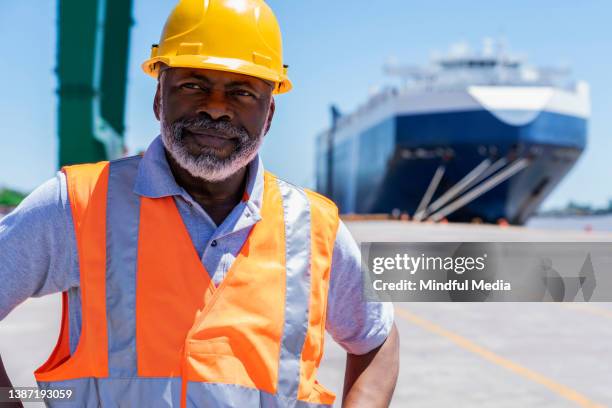 african american male dock worker standing with hands on waist - longshoremen 個照片及圖片檔