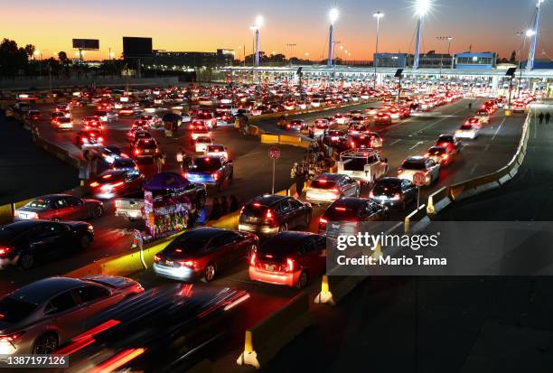 Vehicles wait in line to cross the southern border into the United States at the San Ysidro Port of Entry on March 22, 2022 in Tijuana, Mexico. March...