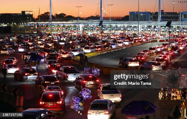 Vehicles wait in line to cross the southern border into the United States at the San Ysidro Port of Entry on March 22, 2022 in Tijuana, Mexico. March...