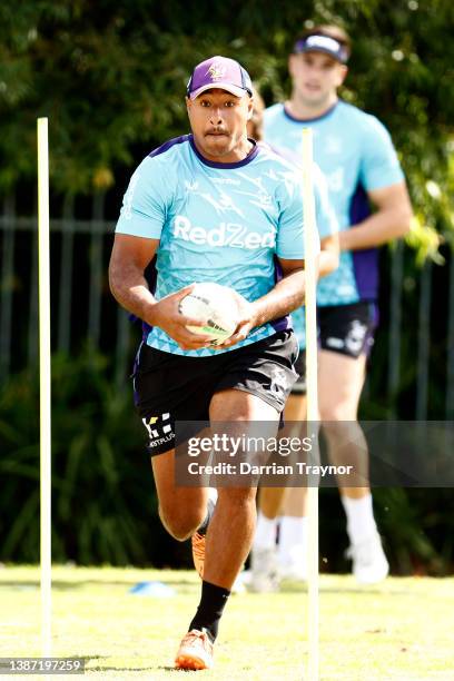 Felise Kaufusi of the Storm runs with the ball during a Melbourne Storm NRL training session at Gosch's Paddock on March 23, 2022 in Melbourne,...