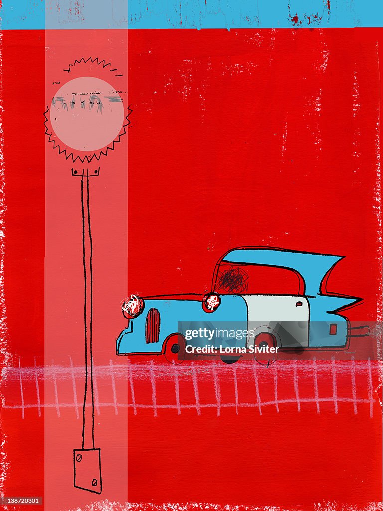 An old fashioned car and a street sign