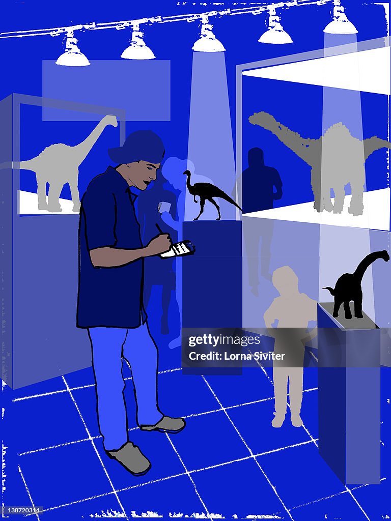A man taking notes at a dinosaur exhibit