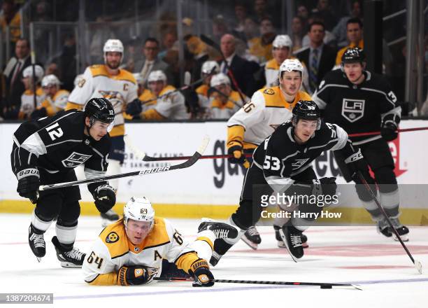 Mikael Granlund of the Nashville Predators reacts as he is tripped by Trevor Moore of the Los Angeles Kings for a penalty and chased by Jordan Spence...
