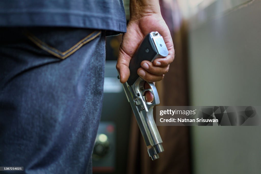 Man carrying a gun to rob the money.