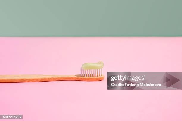 bamboo tooth brush with toothpaste on dual background. zero waste concept. - toothpaste stock pictures, royalty-free photos & images