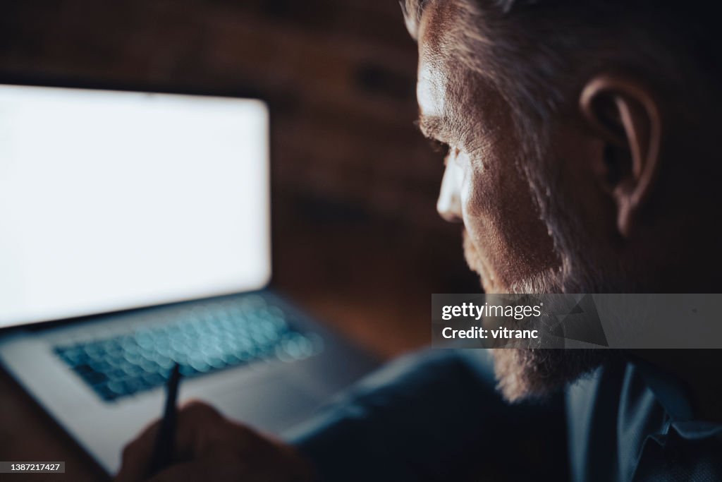 Close up view of businessman writing in notebook
