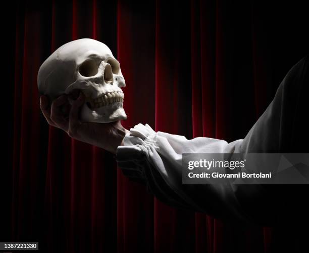 a skull in the hands of an actor, the tragedy of hamlet. - skulls stock pictures, royalty-free photos & images