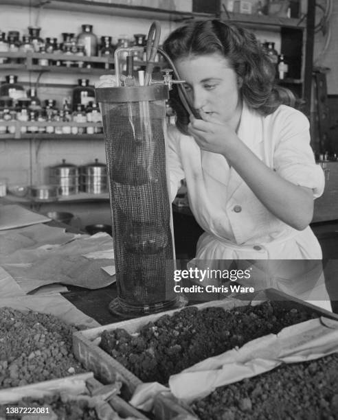 Laboratory assistant analyse the carbonates in soil samples as part of soil analysis at the Experimental Research Station at Cheshunt, Hertfordshire,...