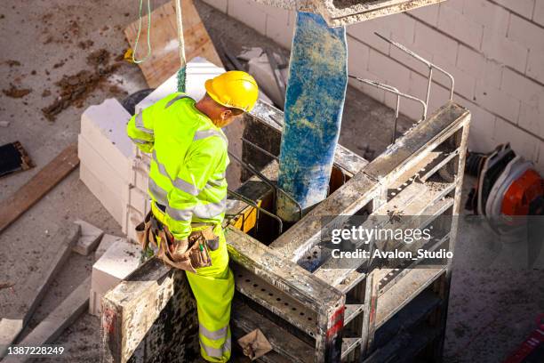 concrete pouring bucket for crane - builders boots stock pictures, royalty-free photos & images