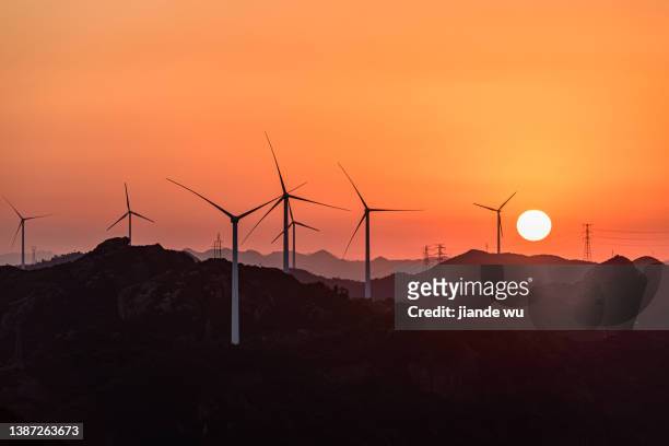 the wind turbine on the top of the mountain, at sunset - film industry photos fotografías e imágenes de stock