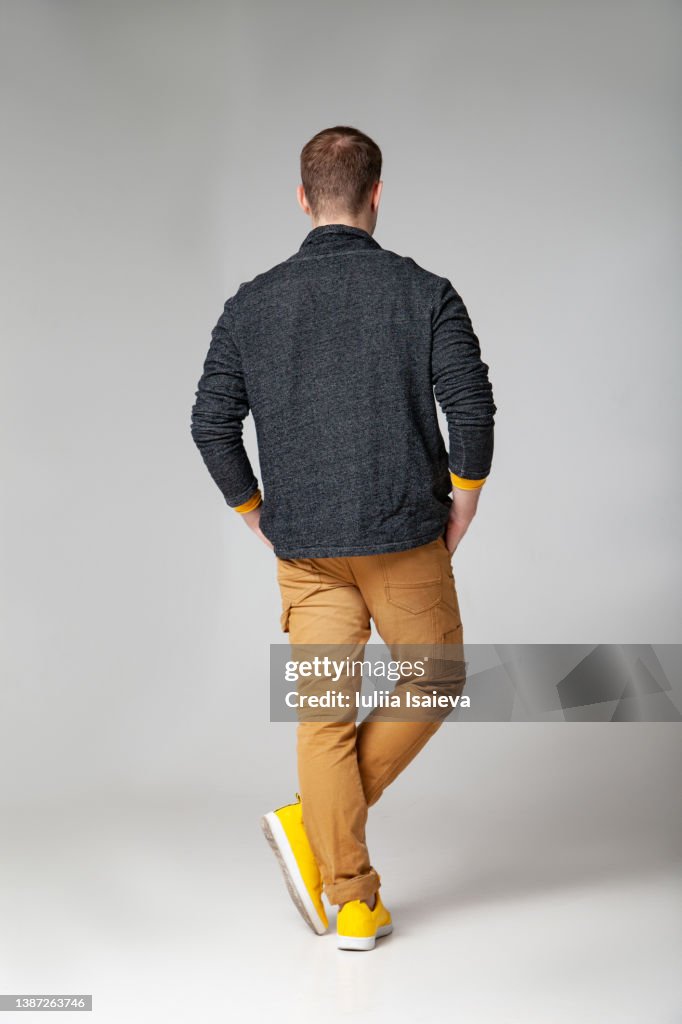 Unrecognizable stylish man standing in studio